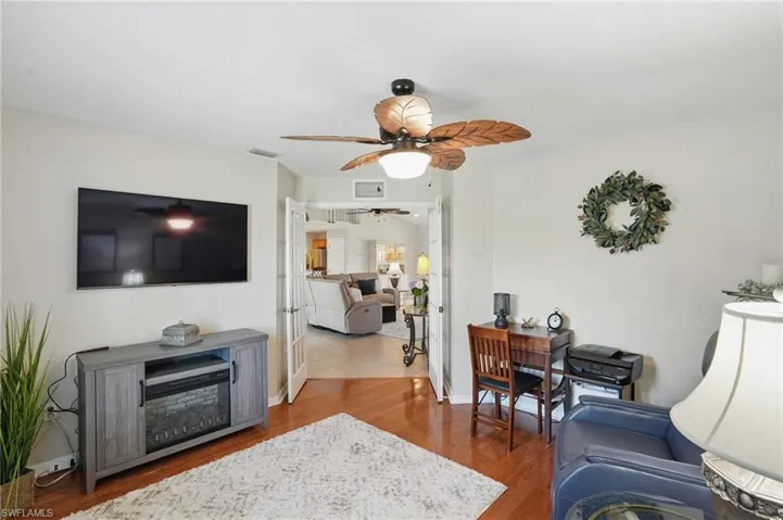 Living room featuring ceiling fan and wood finished floors