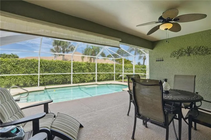 View of pool featuring a patio area, ceiling fan, and a lanai