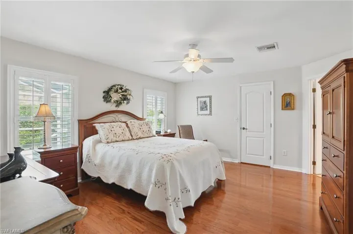 Bedroom featuring wood finished floors, ceiling fan, and baseboards