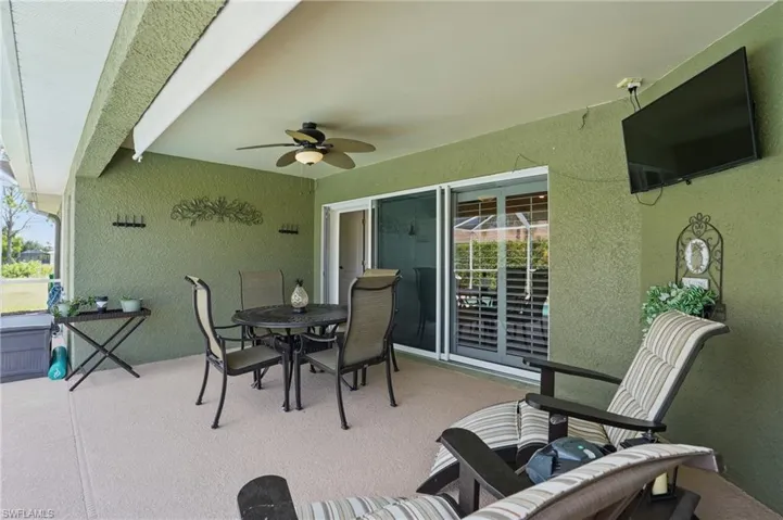 View of patio with ceiling fan and outdoor dining space
