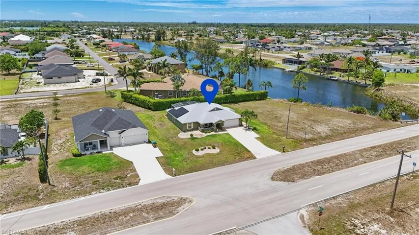 Aerial perspective of suburban area featuring a nearby body of water