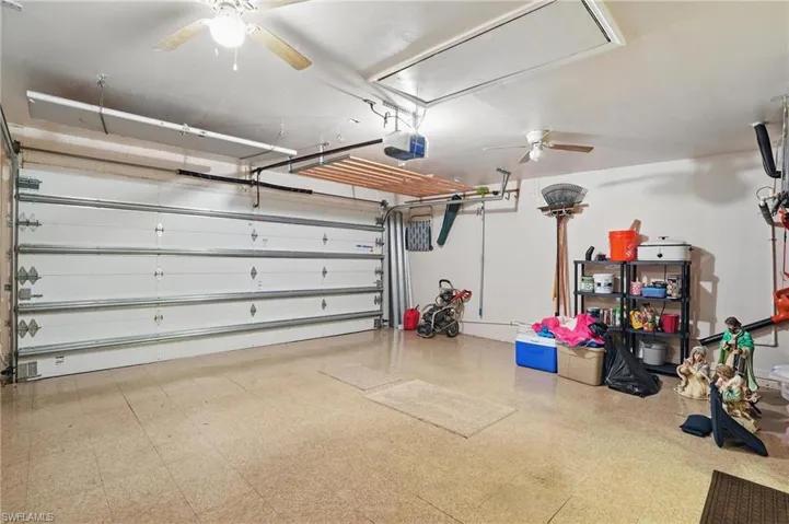 Garage with ceiling fan and a garage door opener