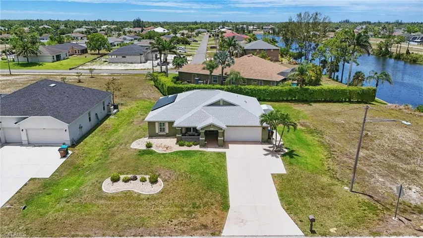 Aerial view of residential area featuring a nearby body of water