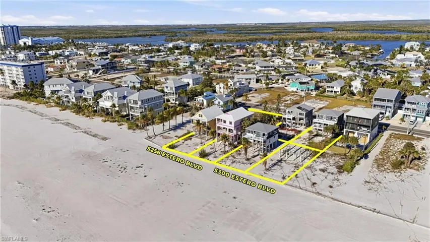 Beachfront land parcels featuring direct sand access and surrounding residential properties