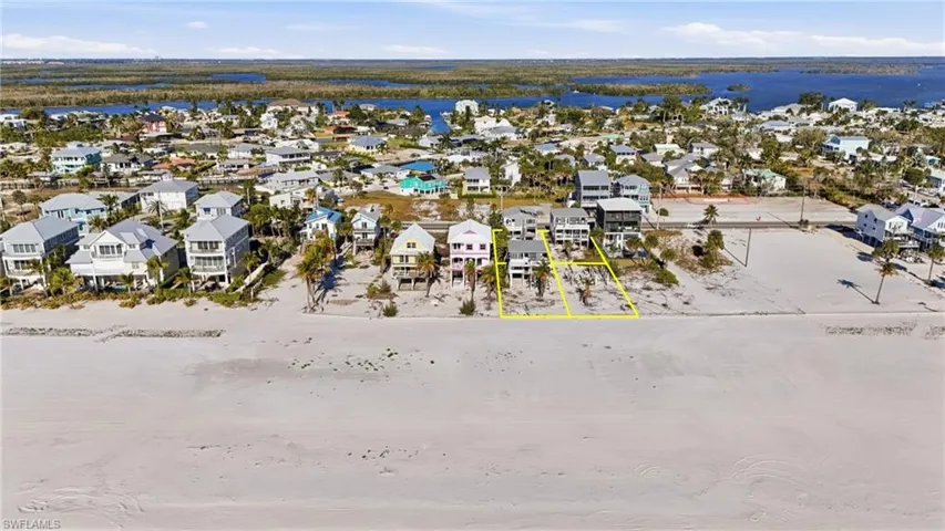 Expansive sandy beach with waterfront properties