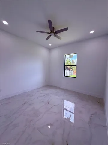 Room featuring polished marble-look tile flooring, a contemporary ceiling fan, and recessed lighting