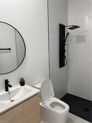 Full bathroom with vanity and a stall shower