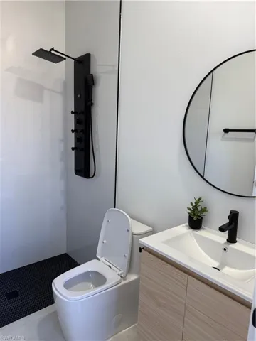 Bathroom featuring vanity and a walk in shower