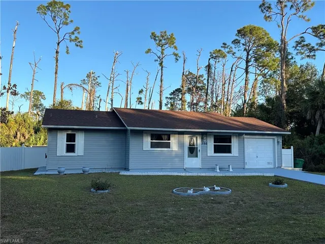 Ranch-style home with a garage and driveway