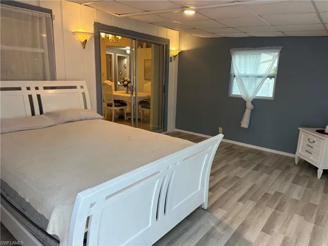 Bedroom featuring light wood-type flooring and a paneled ceiling