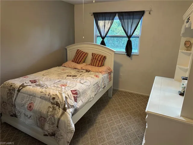 Carpeted bedroom with baseboards