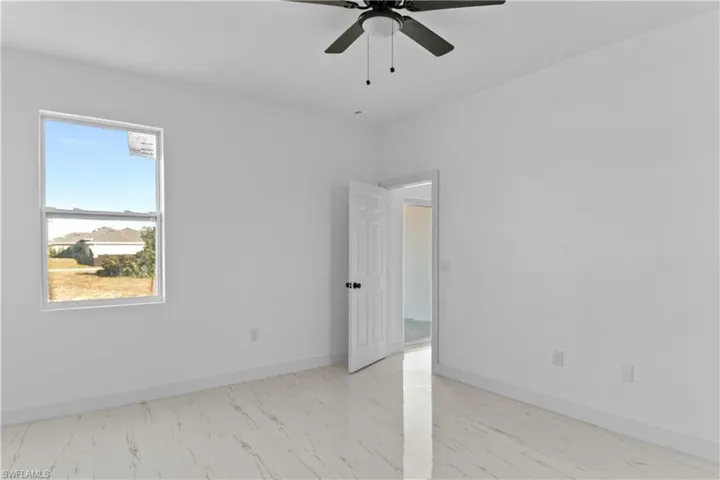 Spare room with ceiling fan