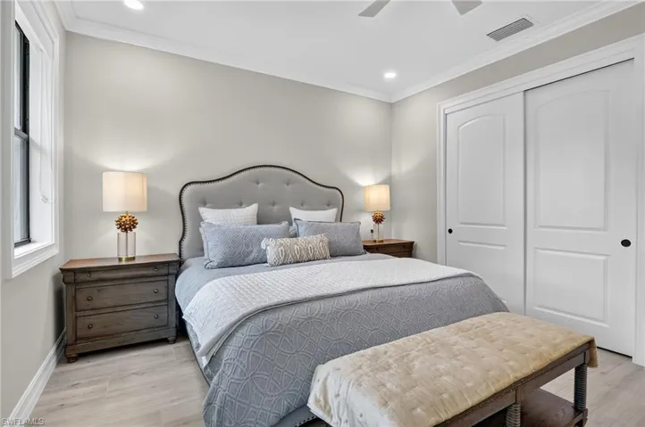 Bedroom featuring light wood finished floors, crown molding, a closet, ceiling fan, and recessed lighting