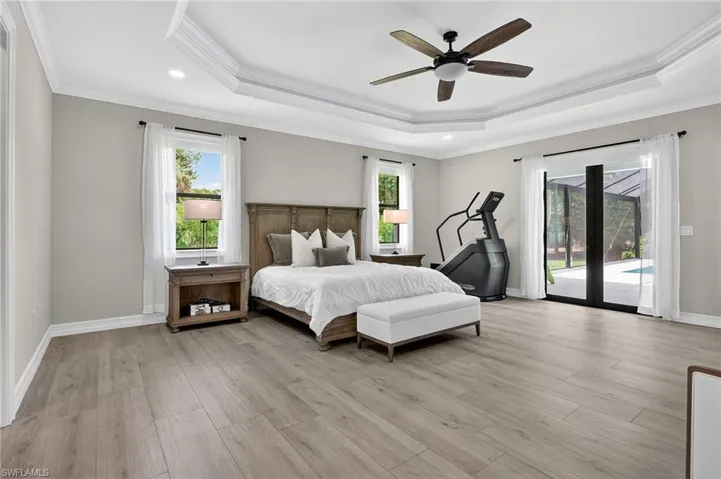 Bedroom featuring crown molding, access to exterior, light wood-type flooring, a ceiling fan, and recessed lighting