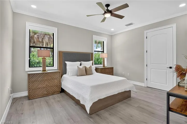 Bedroom with ornamental molding, light wood-style floors, recessed lighting, and a ceiling fan