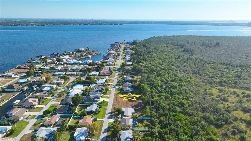 Aerial perspective of suburban area with a nearby body of water
