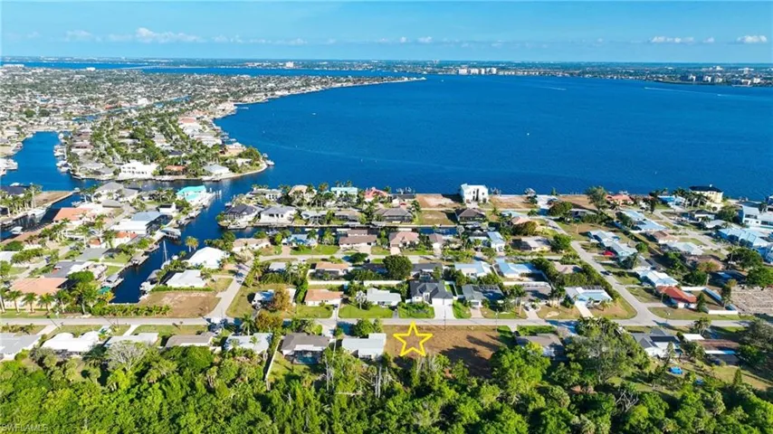 Aerial perspective of suburban area with a large body of water