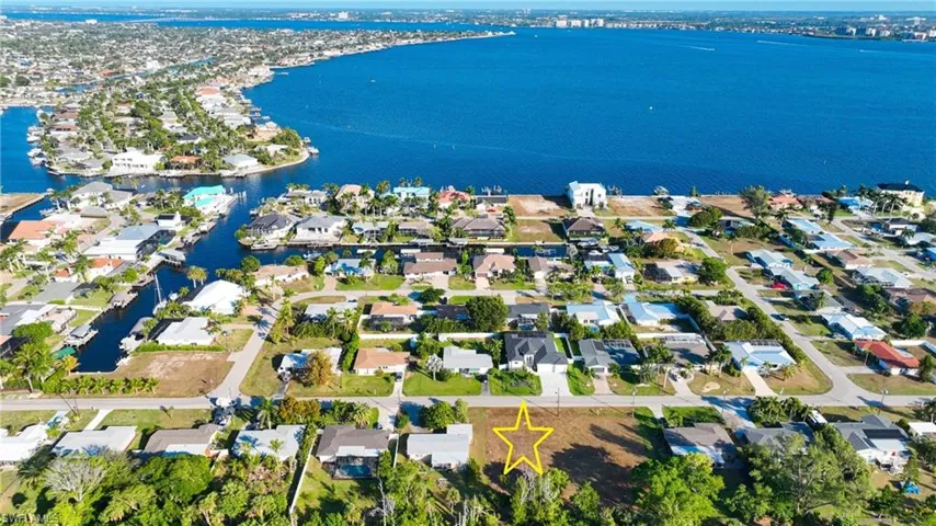Aerial perspective of suburban area featuring a large body of water