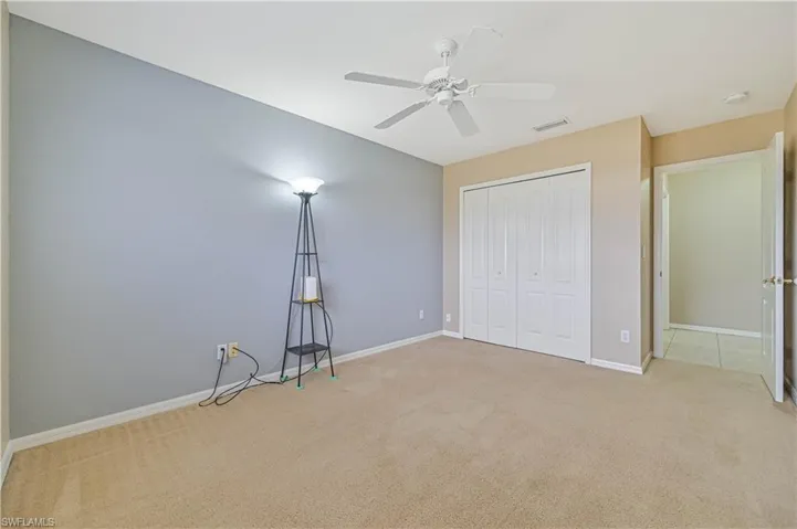 Unfurnished bedroom featuring a closet, carpet flooring, and ceiling fan