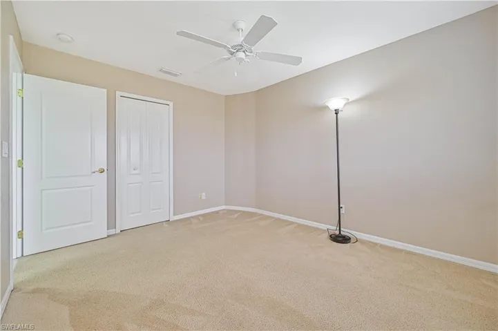 Unfurnished bedroom with carpet and ceiling fan