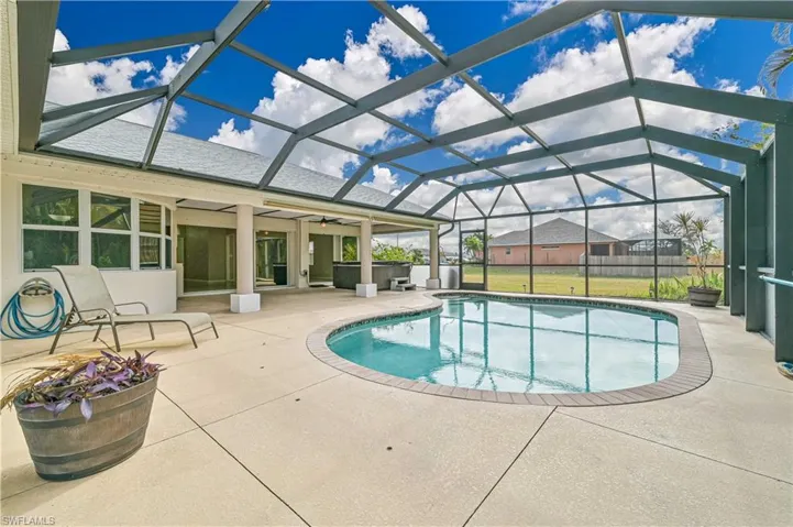 View of swimming pool featuring a patio, a lanai, and ceiling fan