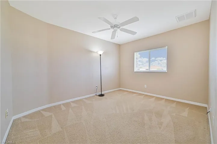 Empty room with carpet flooring and ceiling fan