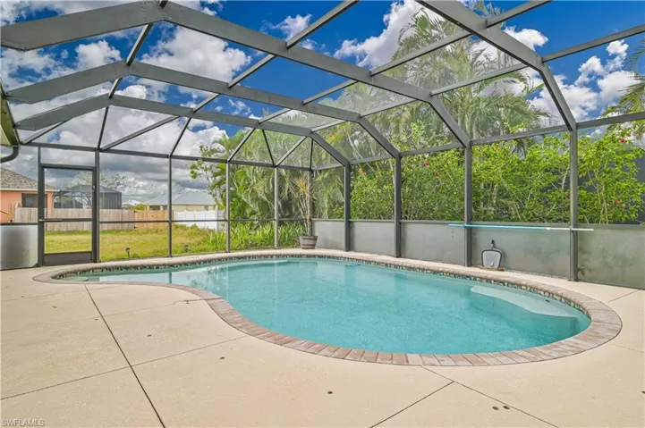View of pool with a patio and a lanai
