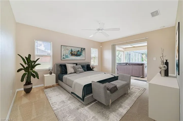 Bedroom with multiple windows, carpet flooring, and ceiling fan