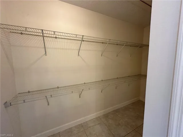 Spacious closet with light tile patterned flooring