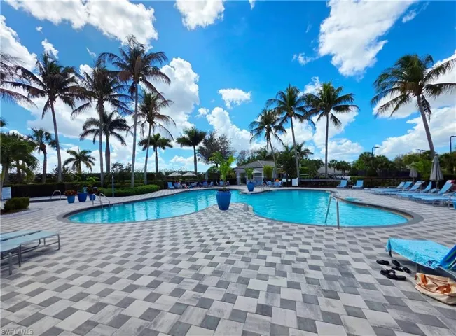 Community pool with a patio