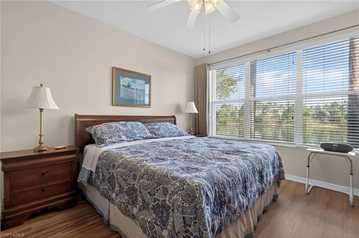 Bedroom featuring dark wood-style floors and a ceiling fan