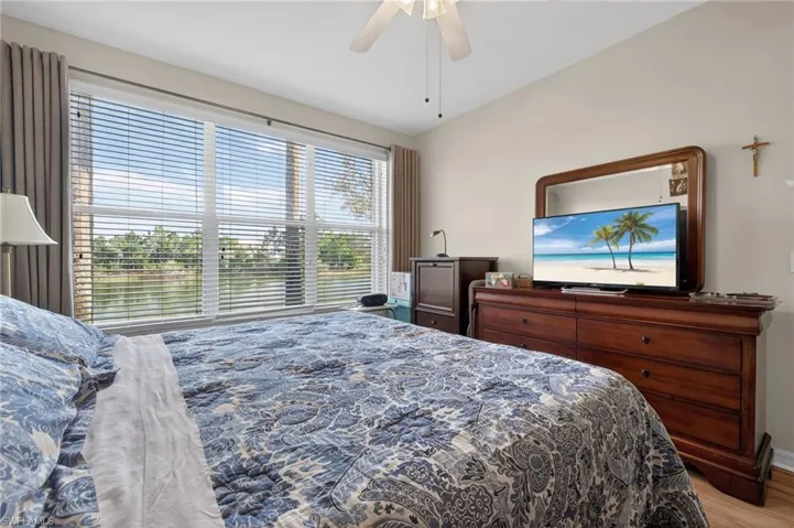 Bedroom with ceiling fan and light wood-style floors