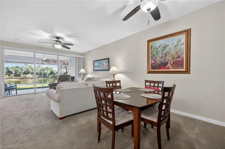Dining room with a ceiling fan and carpet