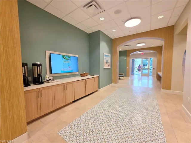 Welcome area featuring arched walkways, recessed lighting, and a paneled ceiling
