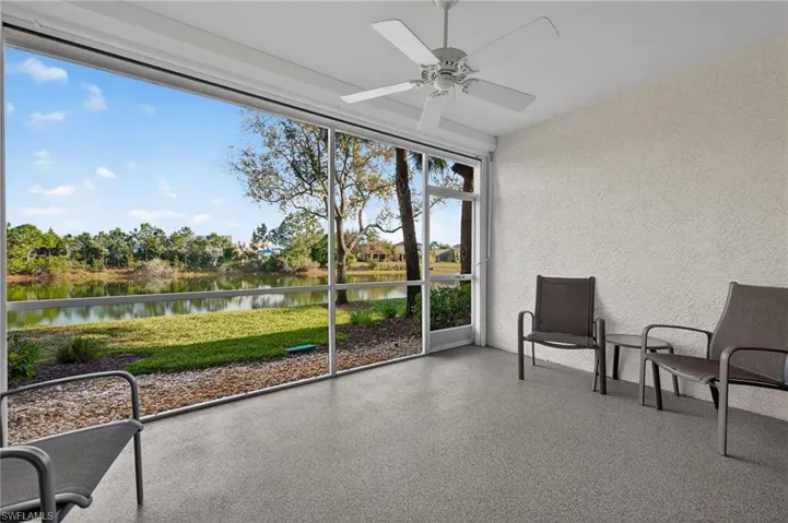 Sunroom featuring ceiling fan and a water view