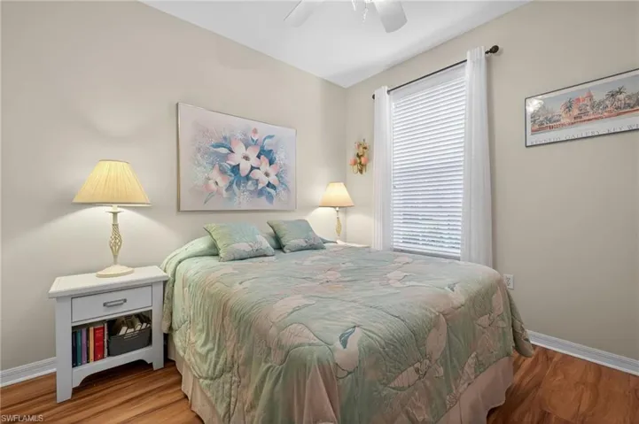 Bedroom featuring wood finished floors and a ceiling fan