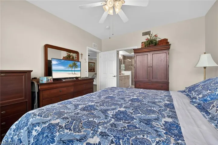 Bedroom featuring a ceiling fan and ensuite bath