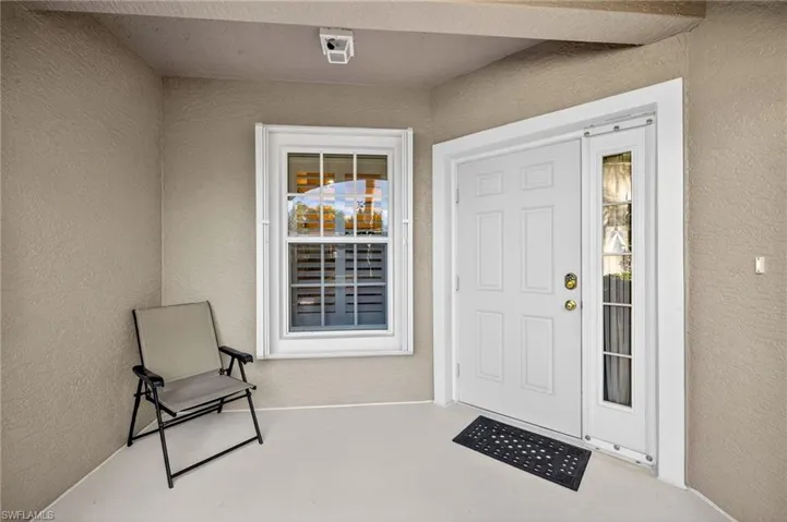 View of exterior entry with stucco siding