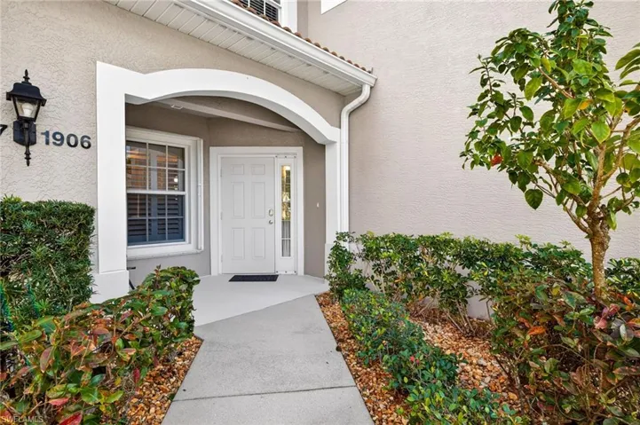 Doorway to property featuring stucco siding