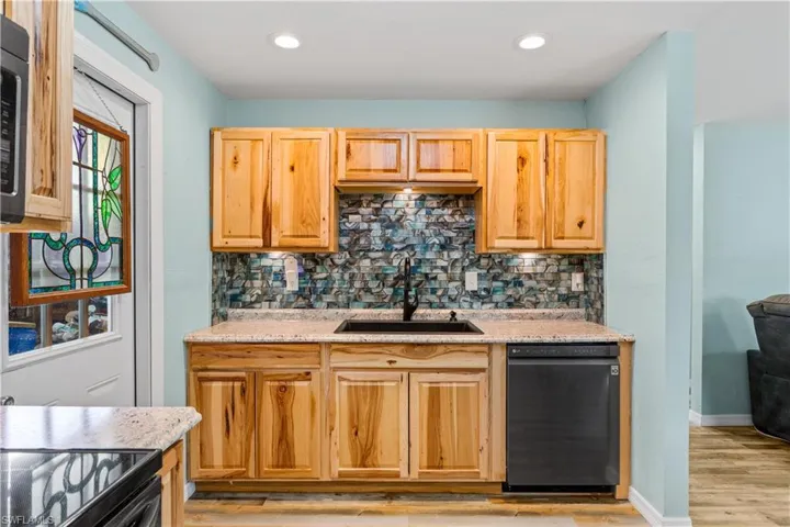14937-Kitchen with decorative backsplash, dishwasher, sink, and light wood-type flooring