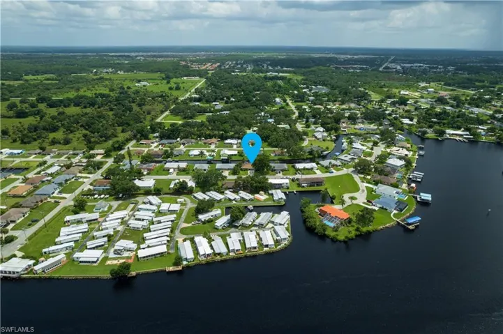 Birds eye view of property with a water view