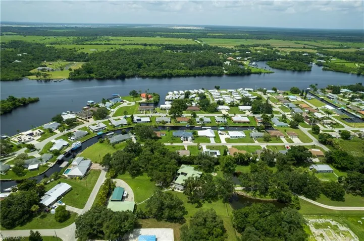 Birds eye view of property with a water view