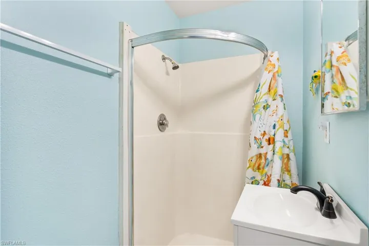 14939-Bathroom featuring vanity and walk in shower