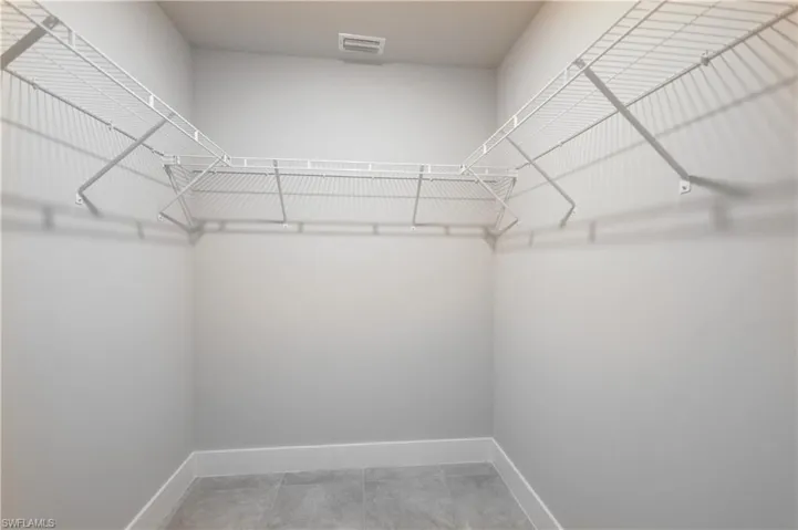 Spacious closet featuring tile patterned flooring