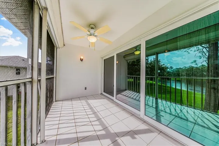 Balcony featuring a ceiling fan and a water view