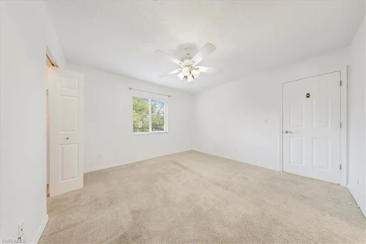 Unfurnished room with light carpet and ceiling fan