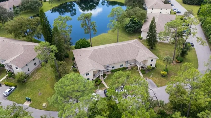 Aerial perspective of suburban area featuring a nearby body of water