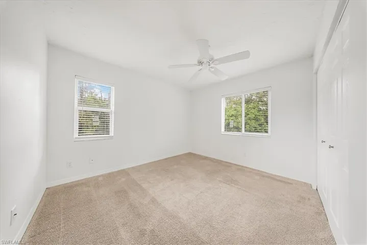 Empty room with light carpet and plenty of natural light