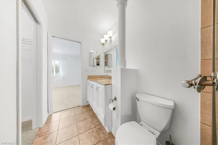 Bathroom featuring light tile patterned floors and vanity