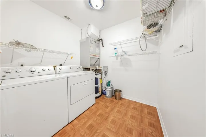 Washroom featuring baseboards and separate washer and dryer